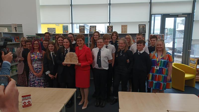 First Minster Nicola Sturgeon is photographed with pupils and teachers in Prestwick High School library holding a reading challenge trophy
